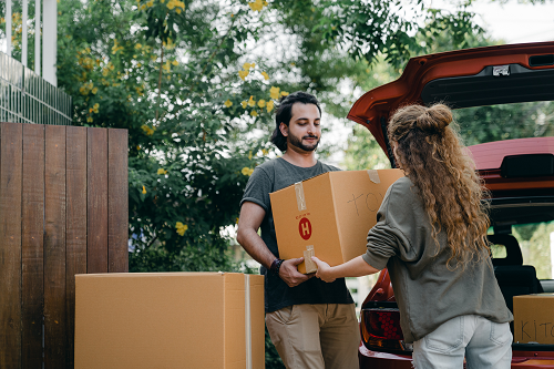 a man and a woman standing in front of a box