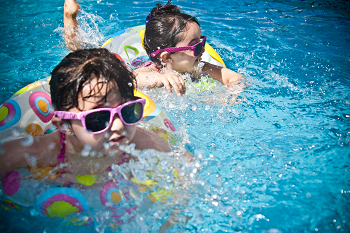 a child swimming in a pool of water