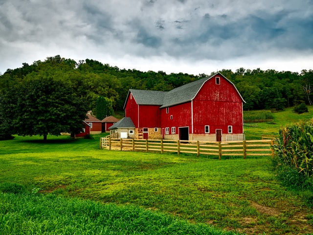 an old barn in a grassy field